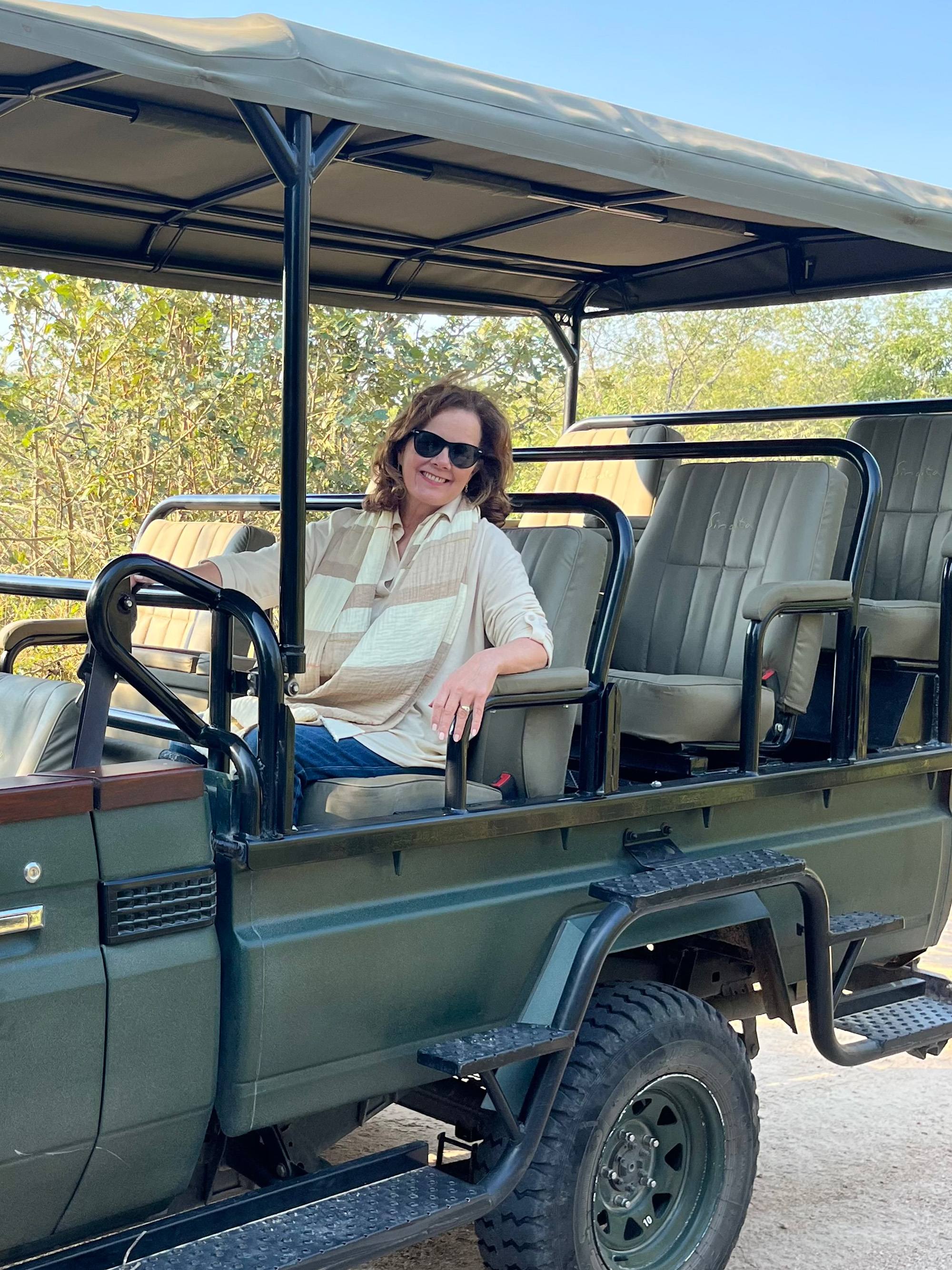 Deb Havens sitting on a safari vehicle